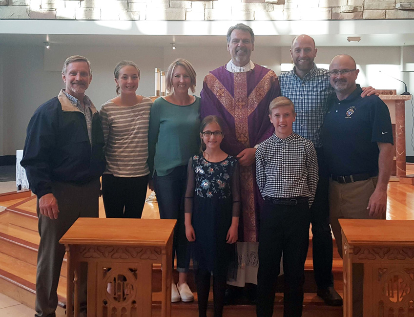 March Knights’ Family of the Month. From left: Family Committee Director Kurt Haneke, Anna, Amanda & Bridget Windholz, Father Bierbaum, Andrew & Eric Windholz and Grand Knight Chet Elder.